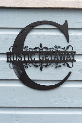 a horseshoe sign on the side of a house at "Rustic Getaway A Charming & Cozy Cottage for Two or Four!" in Geneva