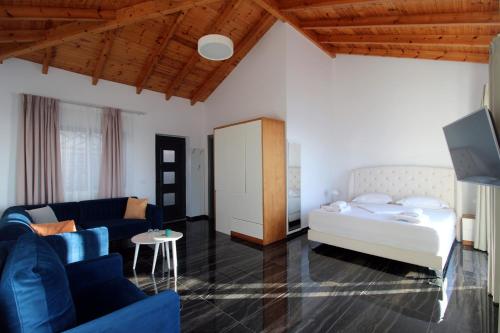 a living room with a bed and a couch at Luxury Pigeons Cave Suites in Ksamil