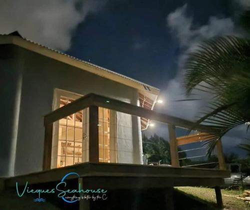 a building with a palm tree in front of it at Cozy chill island roundhouse magic 2 miles from beach-The Vieques Seahouse in Moscou