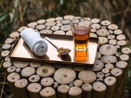 a glass of tea and a towel on a wooden table at Vienna House by Wyndham Andel's Berlin in Berlin
