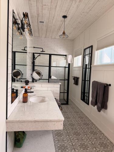 a large bathroom with a sink in a room at Auberge McGowan in Austin