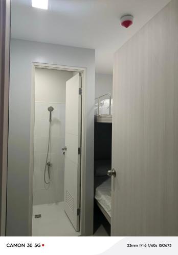 a bathroom with a shower with a mirror at Davao city One Lakeshore Drive at the back of sm lanang in Davao City