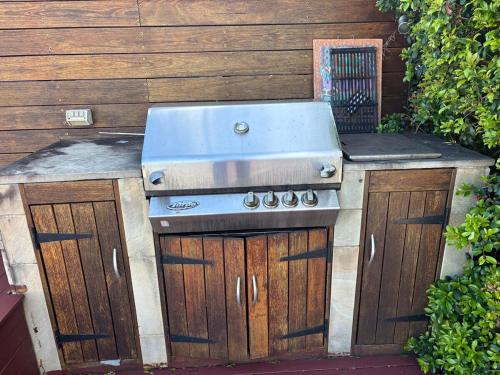 an outdoor grill with a sink and a stove at Bluewater sanctuary in Point Clare