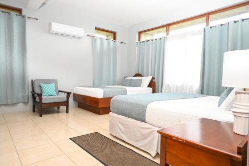 a hotel room with two beds and a desk at Hidden Secret in Gros Islet