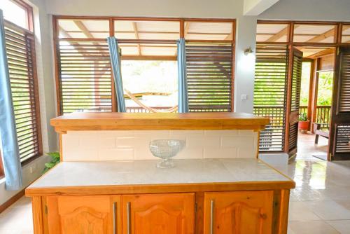 a kitchen with a table with a wine glass on it at Hidden Secret in Gros Islet