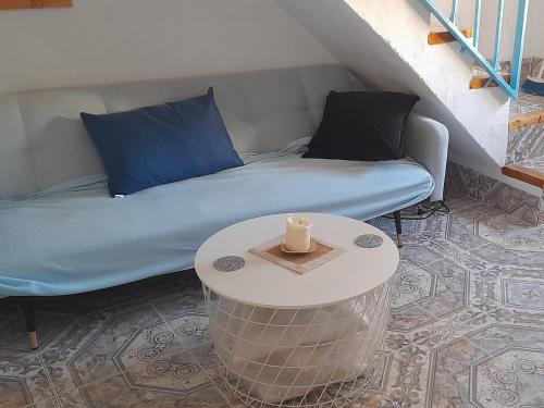 a room with a bed and a table with a candle at A Beautiful Townhouse with a roof top terrace in Rute