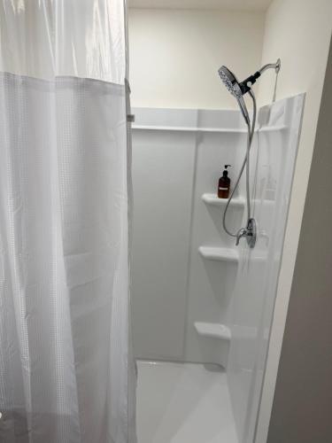 a bathroom with a shower with a white curtain at Paradise in the Springs in Citrus Springs