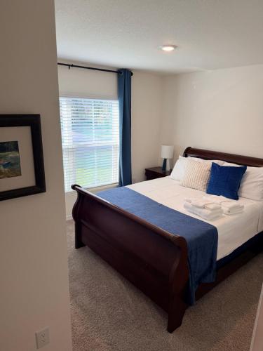 a bedroom with a large bed and a window at Paradise in the Springs in Citrus Springs