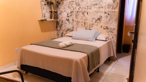 a small bed in a small room with aermottermott at Pousada Cabocla - Centro de Alter in Alter do Chao