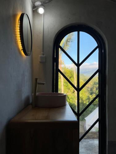 a bathroom with a sink and a large window at KA MANIcamp in Angsri