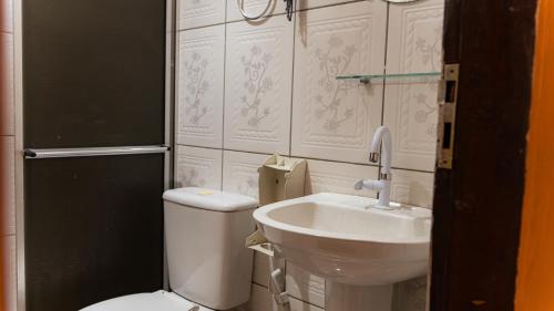 a bathroom with a toilet and a sink at Pousada Cabocla - Centro de Alter in Alter do Chao