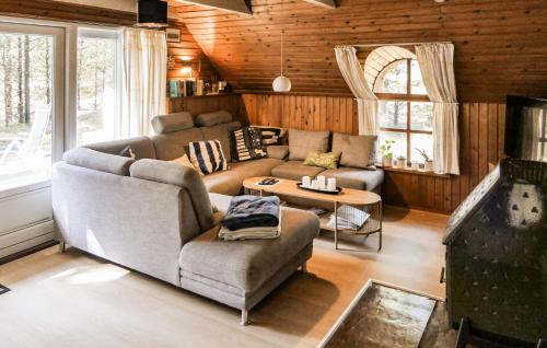 a living room with a couch and a table at Holiday Home Narssagsvej in Rømø