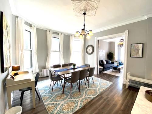 a dining room and living room with a table and chairs at Walk to Wrigley 3BR1BA Sleeps 8 Free Parking in Chicago