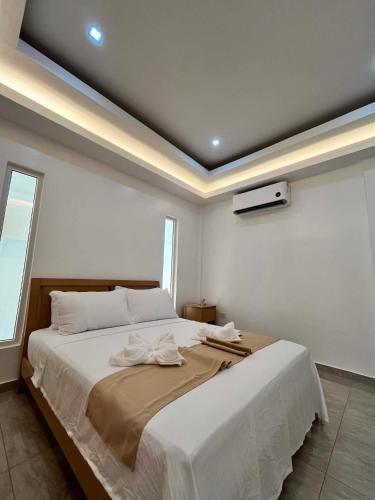 a bedroom with a large white bed in a room at Turtle's Cavern Oceanfront Resort in San Juan