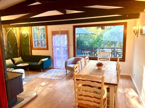 a living room with a table and chairs and a couch at 2 bedroom Guesthouse in the Centre of Noojee in Noojee