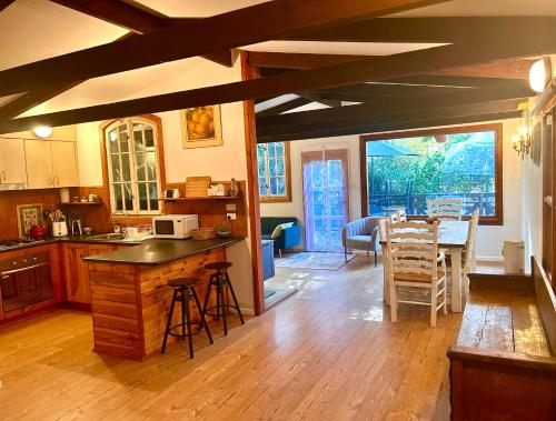 a kitchen with a table and a dining room at 2 bedroom Guesthouse in the Centre of Noojee in Noojee