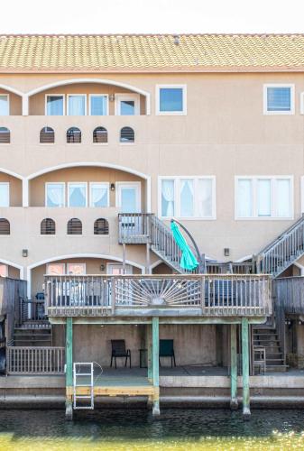 a building with a dock with a slide on the water at La Sirena Pescadora in Corpus Christi