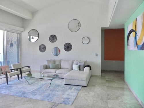 a living room with a couch and a glass table at B Esmeralda Pichilingue PentHouse in Acapulco
