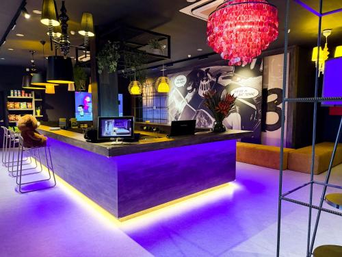 a bar with purple lighting in a restaurant at Bonbon Hotel in Kluang