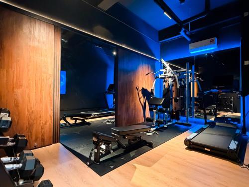 a room with a gym with several tread machines at Bonbon Hotel in Kluang