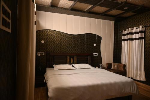 a bedroom with a large bed in a room at The Cloud Cradle in Lāhri