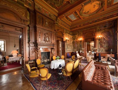 a large room with a couch and a table and chairs at B&B Chateau de Villersexel in Villersexel