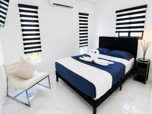 a bedroom with a bed with two swans on it at MG Realty Luxury Stay in Miami