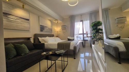 a living room with a bed and a couch in a room at The View at 34th - Sunset Skyline Suite Near SM J Mall & Fiber Wifi in Mandaue City