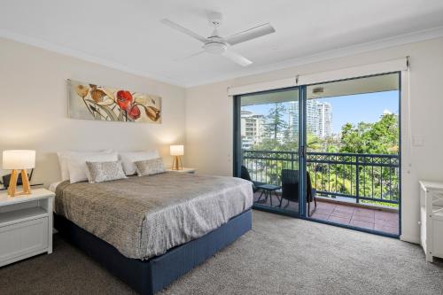 a bedroom with a bed and a balcony at Bella Mare Coolangatta Beachside Apartments in Gold Coast