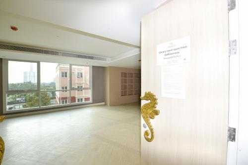 an open door to a room with a large window at Caribbean Hotel Resort Pattaya in Pattaya South