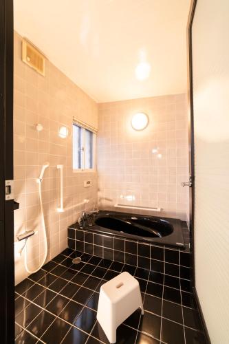 a bathroom with a tub and a toilet and a shower at Morioka base モリオカベース in Morioka