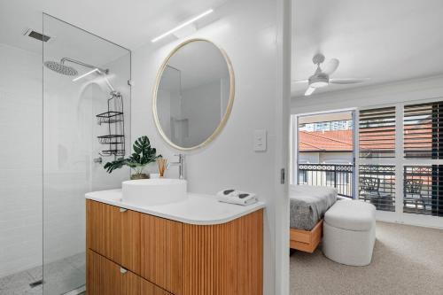 a bathroom with a sink and a mirror at Bella Mare Coolangatta Beachside Apartments in Gold Coast