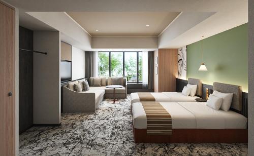 a hotel room with two beds and a couch at Premium hotel MONday MAIHAMA VIEW 2 in Tokyo