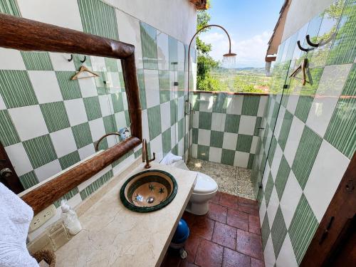 a bathroom with a sink and a toilet with a window at Posada Sueños de Antonio in Barichara