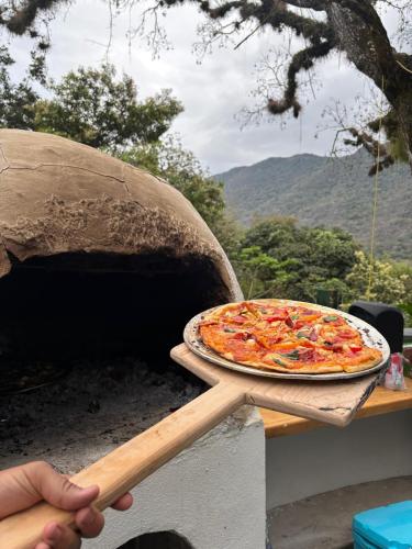 a pizza sitting on top of a pizza oven at Casa Xunaan in Gómez Farías