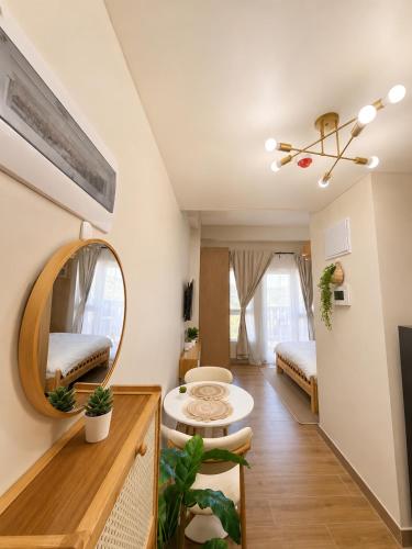a room with two beds and a mirror at Boho-Nordic Studio at Twin Lakes Vineyard, Tagaytay by Cozy Escape in Laurel