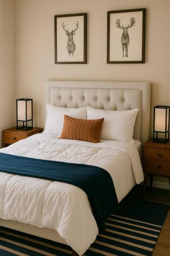 a bedroom with a large white bed with antlers on the wall at Modern Condo • Safe Chicago Stay Near O’Hare in Chicago