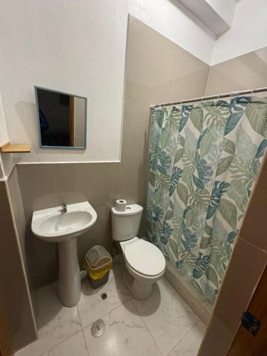 a small bathroom with a toilet and a sink at New Experiences Valle sagrado in Urubamba