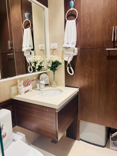 a bathroom with a sink and a mirror at Carolina Peach, Studio unit E-6H Tambuli Resort! in Maribago