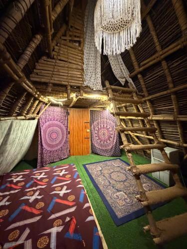 a room with a bed and a chandelier at v kudil in Auroville