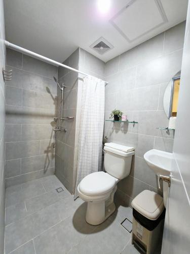 a bathroom with a toilet and a sink at The View at 34th - Sunset Skyline Suite Near SM J Mall & Fiber Wifi in Mandaue City