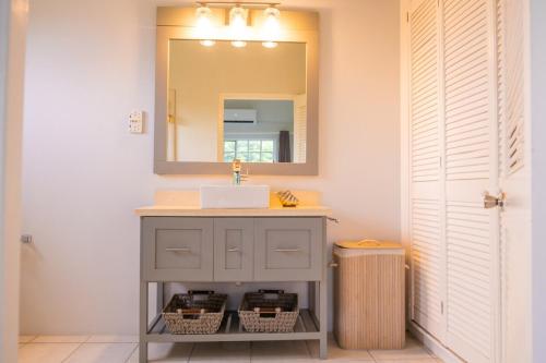 a bathroom with a sink and a mirror at Spacious Apartment Mountain & Sea Views in Mount Helicon