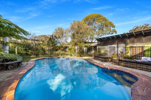 a swimming pool in the backyard of a house at Ma Te Kokorou - pet-friendly Huskisson pool escape in Huskisson