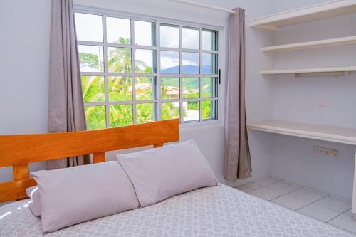 a bedroom with a bed and a large window at Spacious Apartment Mountain & Sea Views in Mount Helicon