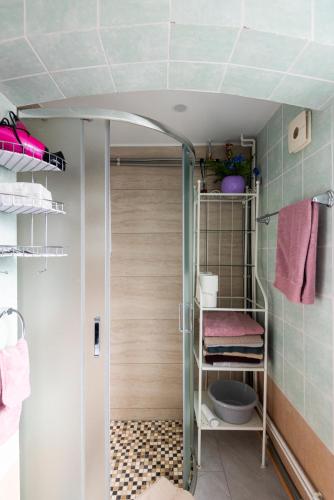 a small bathroom with a toilet and a door at Vila Romantika in Palanga