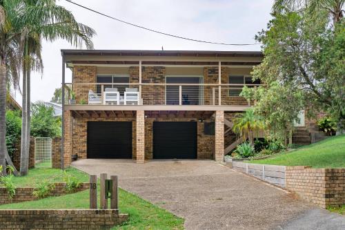 a brick house with two garage doors at Simmons Sanctuary Ulladulla in Ulladulla