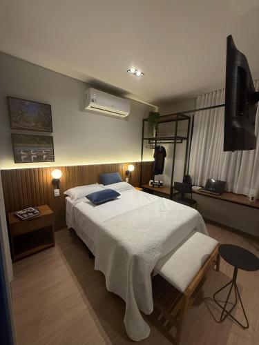 a bedroom with a large bed and a television at Hotel In Loft Elleva Studio in Sinop