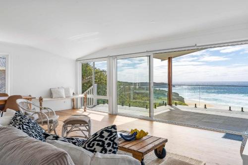 a living room with a view of the ocean at Ocean Overlook - Rennies Beach holiday haven in Ulladulla
