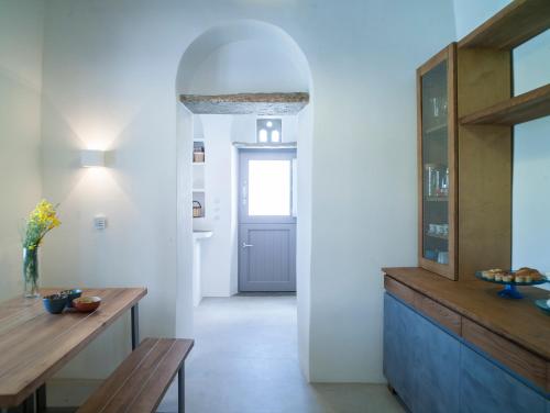 a living room with a table and a door at Tutti Blu Tinos Living Space in Mési