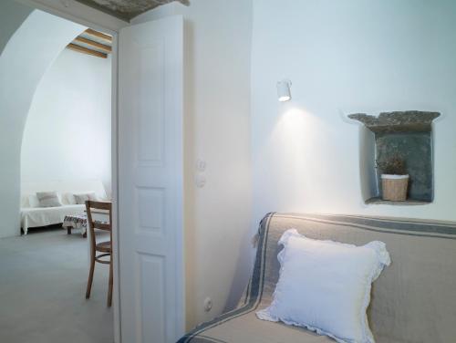 a bedroom with a bed with a pillow on it at Tutti Blu Tinos Living Space in Mési